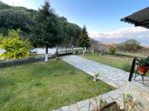 a garden with a stone walkway in the grass at HOUSE BTS(BY.THE.SEA) in Stavros
