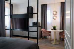 a bedroom with a bed and a tv and a table at Candy Ballerina No 2 Zagreb Center - top positon Lux in Zagreb