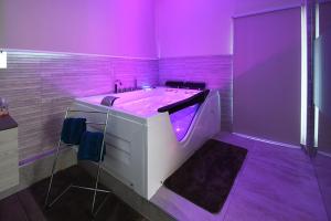 a purple bathroom with a tub with purple lighting at Appartement Loft Detente in Strasbourg