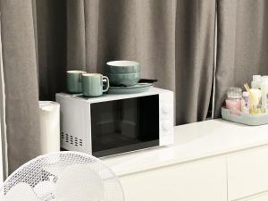 a microwave with two cups on top of it at Minet Gardens House - Suite 6 in London