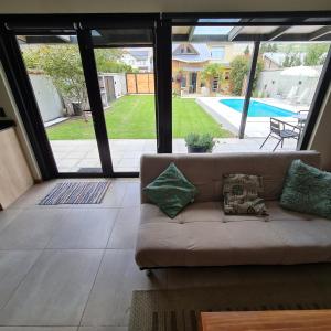 a living room with a couch and a view of a pool at Olivo Apartment in Esquel