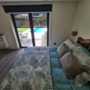 a bedroom with a bed and a view of a pool at Olivo Apartment in Esquel