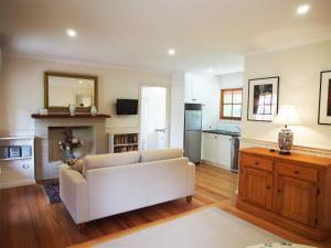 a living room filled with furniture and a fireplace at Tahara Cottage in Deloraine