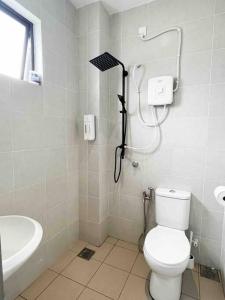 a bathroom with a shower and a toilet and a sink at Comfy Sofy 23- Balcony Garden (Night market) in Tanah Rata +27 photos