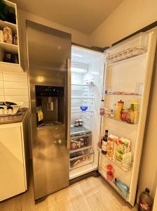 a refrigerator with its door open in a kitchen at Central and cozy next to Oslo S in Oslo