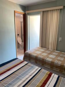 Cama o camas de una habitación en Apartamento Confortável