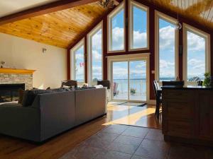 a living room with a couch and a fireplace at SouthLake Cottage on The Lake. in Washago