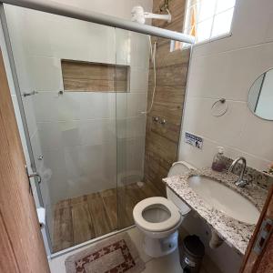 a bathroom with a shower and a toilet and a sink at Sítio Sonho da Vovó in Esmeraldas +37 photos