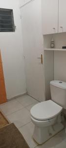 a bathroom with a white toilet in a room at L'étonnant F3 Joris in Saint-Pierre