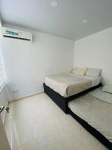 a bedroom with two beds in a room at Casa en condominio Bahia Solero - Torrosa in Ricaurte