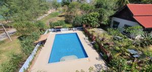 an overhead view of a swimming pool next to a house at Pandan Laut Beach Resort in Kampung Penarik