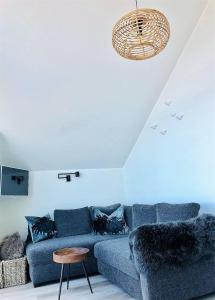 a living room with a blue couch and a table at Meeresblick-Strandkieker-Haus-3-WE-45 in Hohwacht