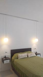 a bedroom with a green bed with two lamps at Casablanca Chacras in Chacras de Coria