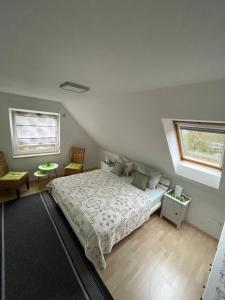 a bedroom with a bed and two windows at Oase der Ruhe 2 in Waldsieversdorf