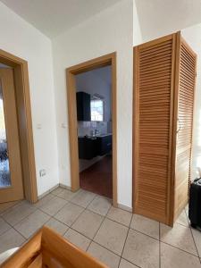 a room with two doors and a room with a kitchen at Oase der Ruhe 2 in Waldsieversdorf