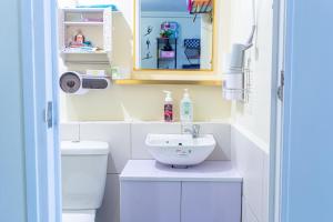 a bathroom with a sink and a toilet at Pandora's Nest in Manila