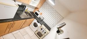 an overhead view of a kitchen with a washing machine at Fantastic - Centrally located 1 bed APT with Wi-fi in Dalkeith