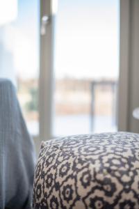 a close up of the corner of a couch with a pattern at CAMPO SUITES in Kampos Paros