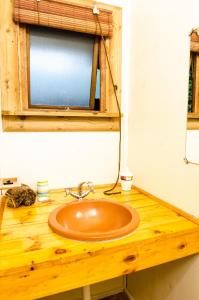 a bathroom with a wooden counter with a sink at Hippo Water Front Lodge in Nelspruit