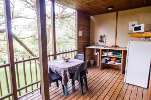a small kitchen with a table and a refrigerator at Hippo Water Front Lodge in Nelspruit