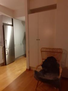 an empty room with a chair and a refrigerator at Two room Apartment in Sundbyberg Stockholm in Sundbyberg