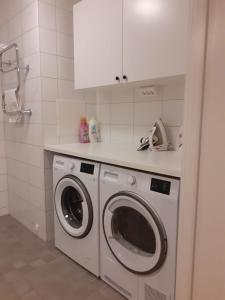 a kitchen with a washing machine and a sink at Two room Apartment in Sundbyberg Stockholm in Sundbyberg