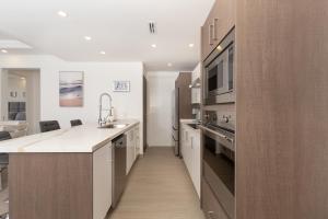 A kitchen or kitchenette at Brand New Contemporary 2 BD Oceanfront Condo at Encantame Towers Verano E302