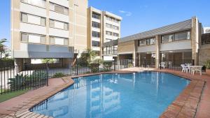 a large swimming pool in front of a building at Oceanic Unit 4 Kings Beach QLD in Caloundra