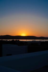 a sunset from the roof of a building at CAMPO SUITES in Kampos Paros