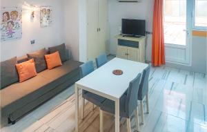 a living room with a couch and a table at Cozy Apartment In Torremolinos With Wifi in Torremolinos