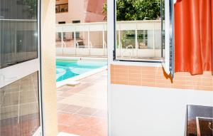 a view of a swimming pool from a house at Cozy Apartment In Torremolinos With Wifi in Torremolinos
