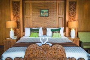 a bedroom with a large bed with two lamps at Panviman Resort Koh Phangan - SHA Extra Plus in Thong Nai Pan Noi