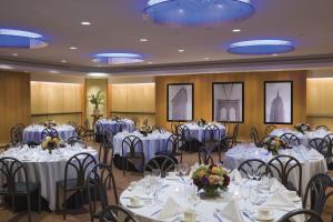 a banquet room with tables and chairs with white tablecloths at Millennium Hotel Broadway Times Square in New York