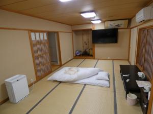 Postel nebo postele na pokoji v ubytování Hotel Tsuchiya