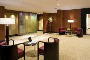 a lobby with chairs and a table with a laptop at Millennium Hotel Broadway Times Square in New York
