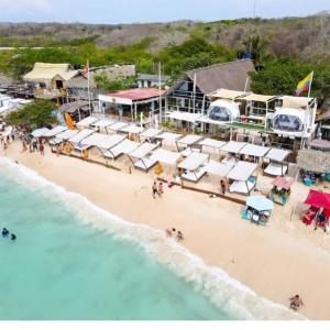 an aerial view of a beach with a group of umbrellas at NENA BEACH CLUB & HOTEL in Baru