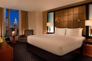a hotel room with a large bed and a chair at Millennium Hotel Broadway Times Square in New York