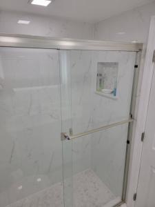 a shower with a glass door in a bathroom at 3509 Luxury Location and Location in Orlando