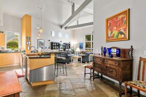 a large room with a kitchen and a living room at 4000 sq ft Resort Home Near Carlsbad Beaches! in Carlsbad