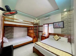 a bedroom with two beds in a room at Phong Nha Tuan Garden House in Phong Nha +51 photos
