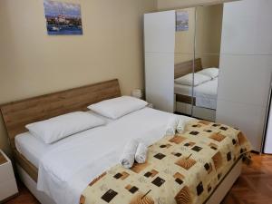 sypialnia z łóżkiem z białą pościelą i ręcznikami w obiekcie Apartment in Vrsi with Air conditioning, WIFI, Washing machine, Dishwasher (4836-1) w mieście Vrsi +37 zdjęć