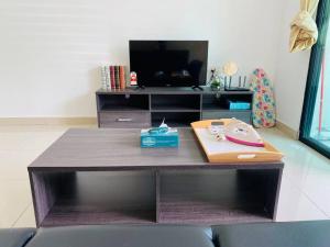 a wooden table with a desk in a living room at The Meadow Park 4R4B in Kampar