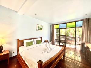 a bedroom with a bed and a large window at Baan Pai Nai Wieng in Pai