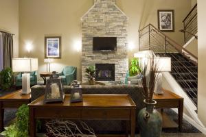 a living room with a couch and a fireplace at GrandStay Hotel & Suites - Glenwood in Glenwood