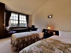 Postel nebo postele na pokoji v ubytování Petit Hotel Kanan