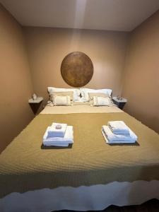 a bedroom with a bed with towels on it at Tanah Loft - in Villa Mercedes