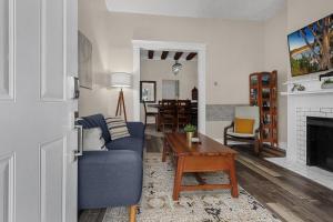 a living room with a blue couch and a table at Modern 2BR near DT, 8min walk to Park&Conservatory in Columbus