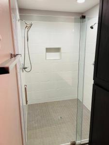 a shower stall with a glass door in a bathroom at Sandstone Ridge Apartments Remodeled 6 Bedroom 4 Bath in Oklahoma City