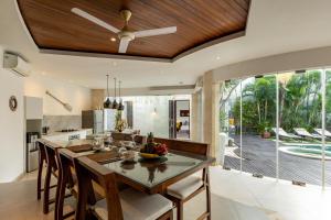 an open kitchen and dining room with a table and chairs at Villa Belle Seminyak by Bali Villas R Us in Seminyak