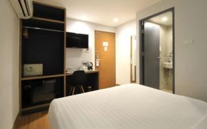 a hotel room with a bed and a bathroom at Mybed Sathorn Hotel in Bangkok